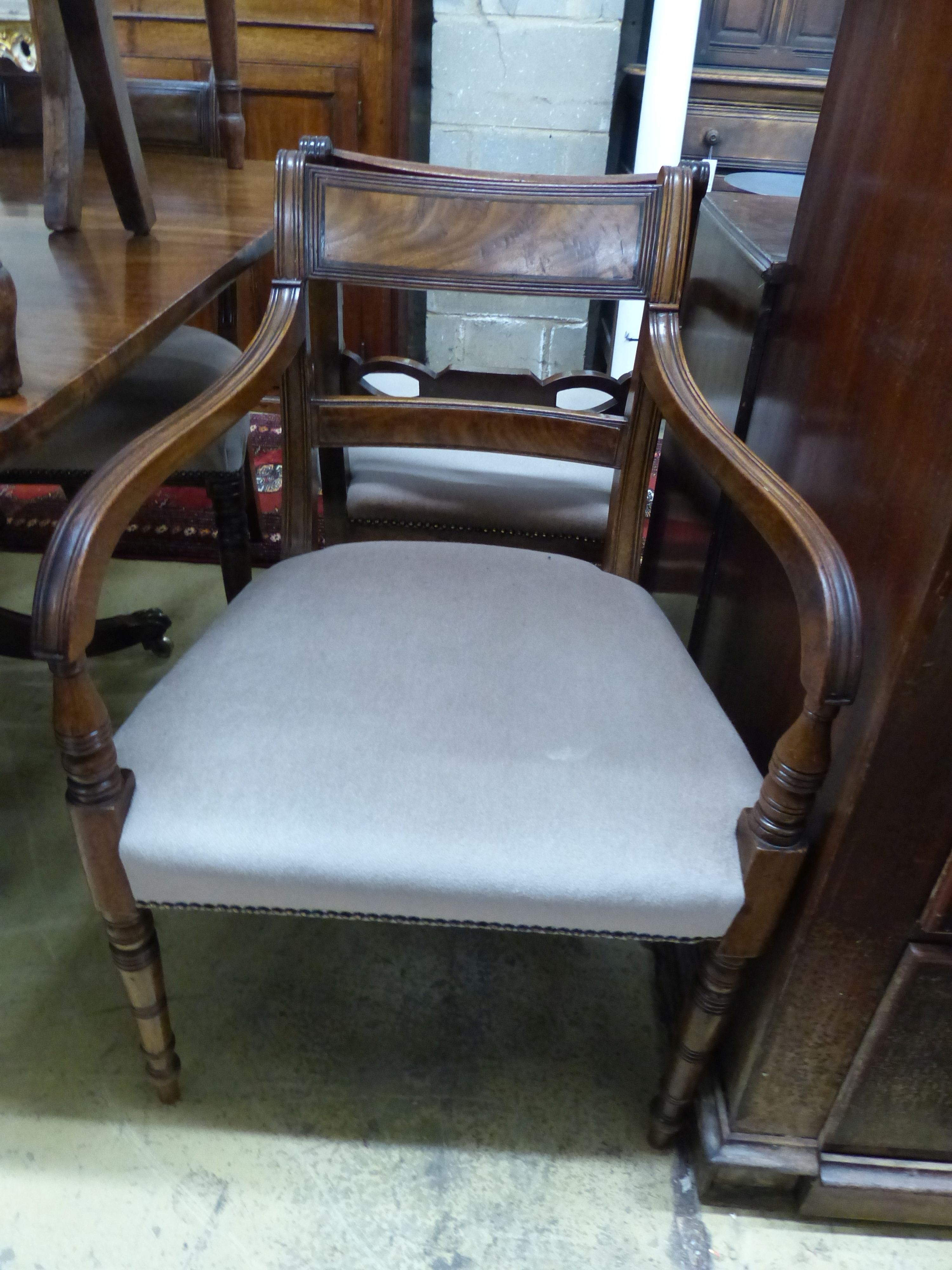 A Regency mahogany tilt top dining table, together with a harlequin set of ten Regency mahogany dining chairs (four with arms), table 122 x 118cm H.72cm